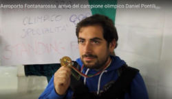 Un primo piano di Daniel Pontili che mostra la medaglia olimpica